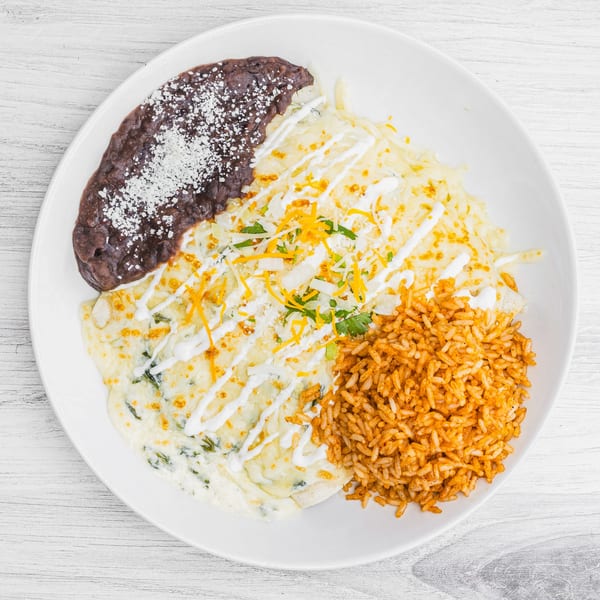 Prados Modern Mexican Cantina's enchiladas with rice and refried beans, topped with cheese and sour cream.
