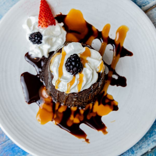 Prados' chocolate lava cake with whipped cream, blackberry, strawberry, and caramel drizzle.
