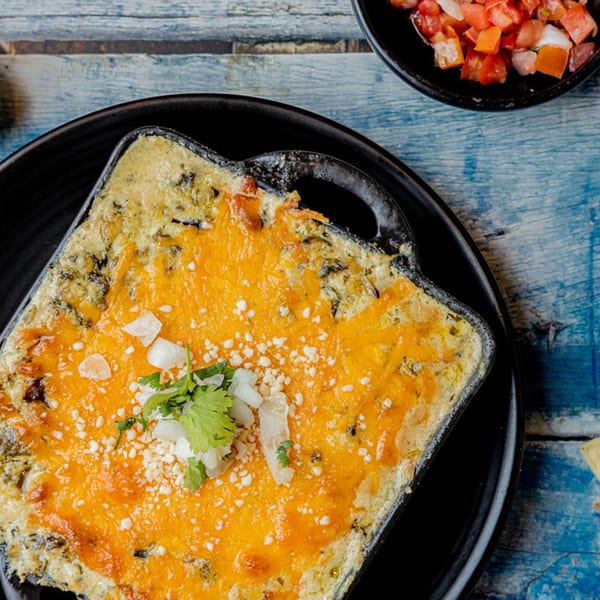 Prados Modern Mexican Cantina's queso fundido, a melted cheese dip with cilantro and onions, served with pico de gallo.