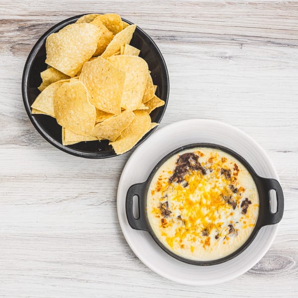 Prados Modern Mexican Cantina's queso fundido with melted cheese and black beans, served with tortilla chips.