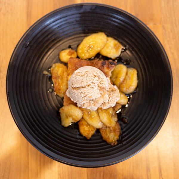 Prados Modern Mexican Cantina's dessert with a scoop of ice cream on top of fried bananas.